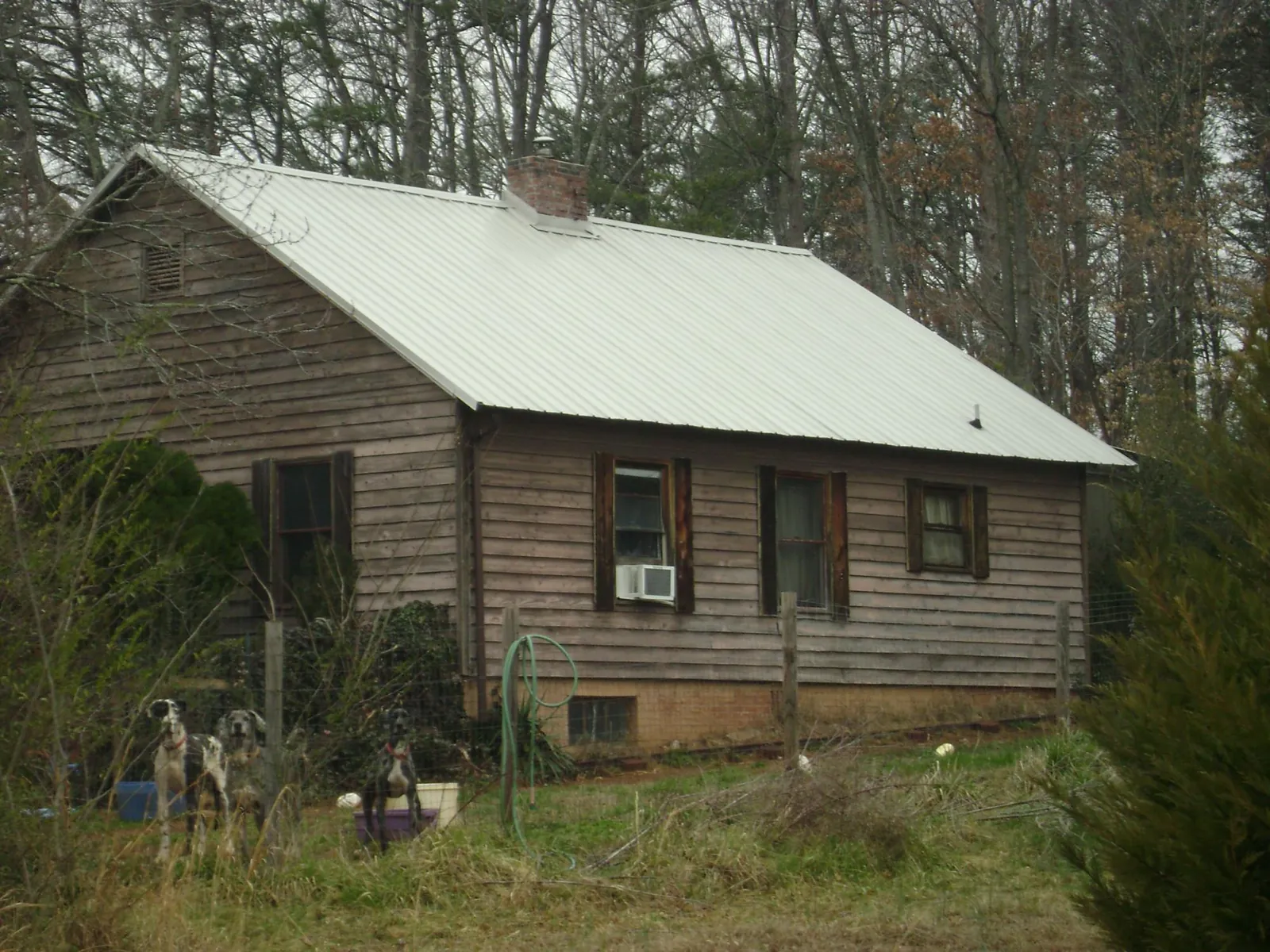 White metal roof on an old wood sided farmhouse, from a Metal Roof Installation job in Smoaks